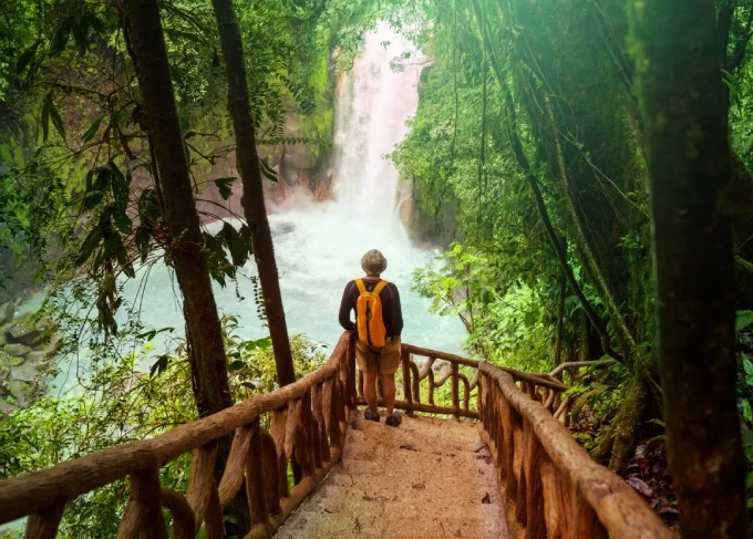 Hiker overlooking a waterfall in Costa Rica