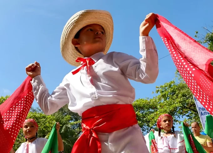 Children dancing with red scarves at traditional festivals in Costa Rica