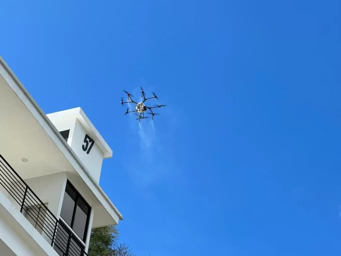 Drone spraying for dengue in Costa Rica from above a building